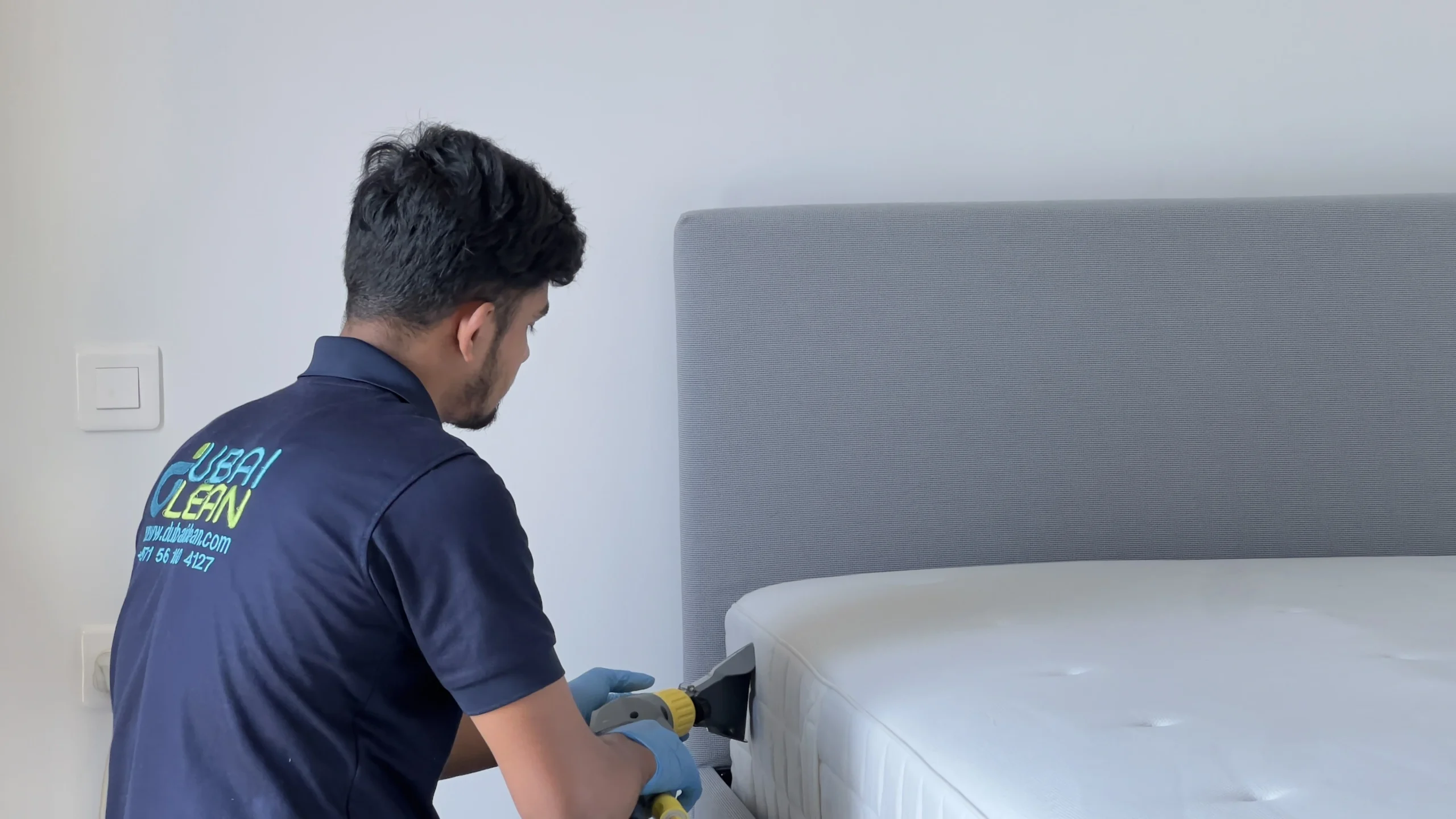 Mattress cleaning in progress with vacuum and steam tools