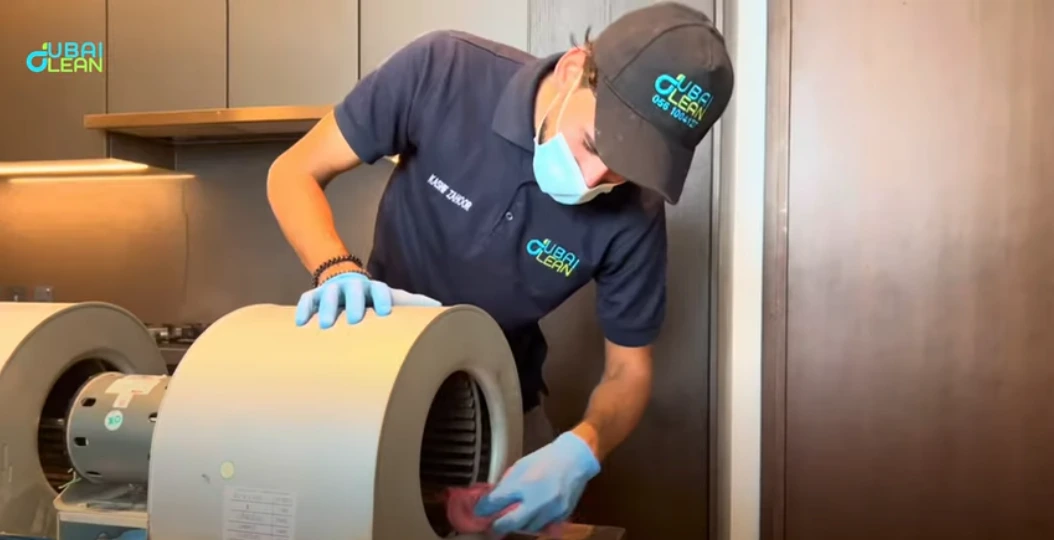 Technician cleaning dusty AC coil with specialized tools to improve cooling performance