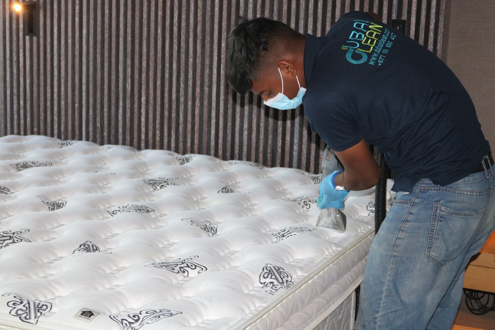 Mattress cleaning in progress with vacuum and steam tools