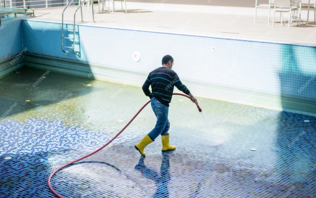 Professional swimming pool cleaning with vacuum, skimmer, and clear blue water