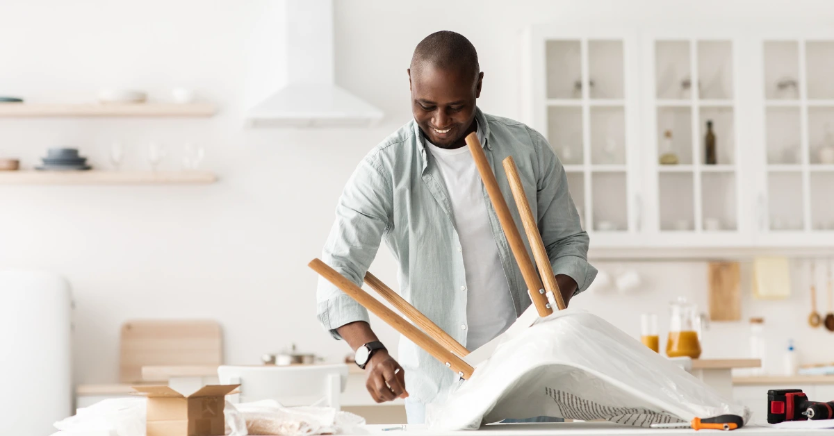 Modern furniture wrapping in progress using wood-textured vinyl on a table