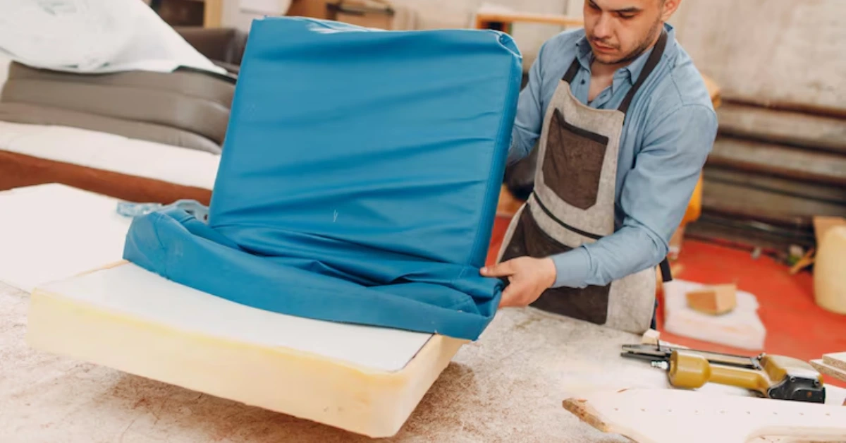 Modern furniture wrapping in progress using wood-textured vinyl on a table