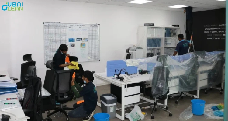 Office deep cleaning process – professionals sanitizing workplace surfaces and equipment