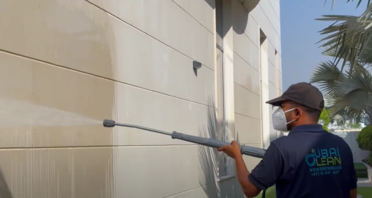 Facade cleaning service in progress on a high-rise building with visible shine and clarity