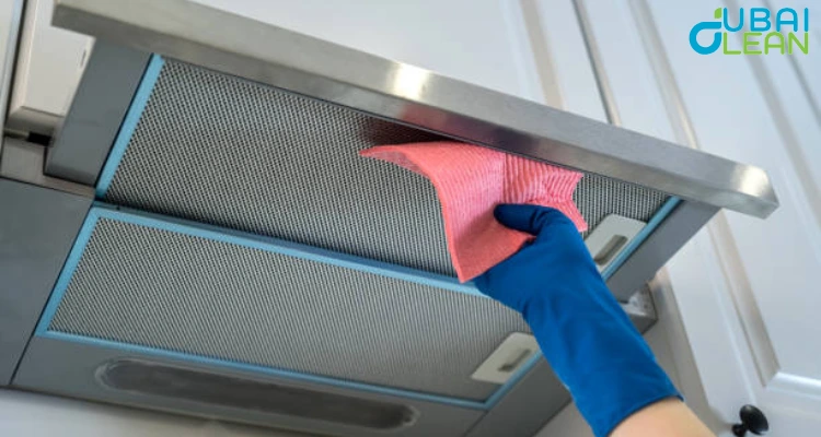 Kitchen hood cleaning in progress to remove grease buildup and improve fire safety